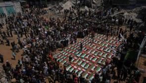 Bodies of members of the Hassayna and Abu Sharia families, killed in an Israeli strike in 2023 and recently recovered from the rubble, are draped in Palestinian flags during their funeral in Gaza City, Tuesday, Aug. 4, 2026. Photo: AP