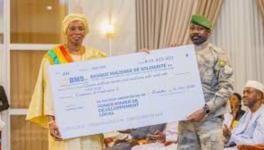 Colonel Assimi Goita distributes mining checks to vulnerable communities in Mali. Photo: Mali Presidency/FB