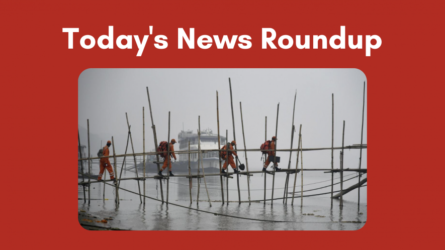 State Disaster Response Force (SDRF) personnel cross the River Brahmaputra through a bamboo bridge on a cold and foggy morning, in Guwahati, on Dec. 27, 2022