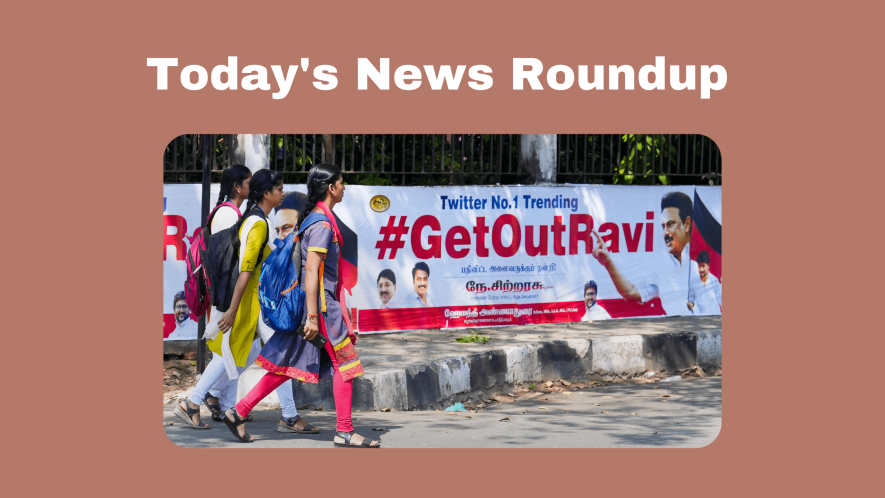 Young women walk past posters that read '#GetOutRavi' pasted on a wall, a day after Tamil Nadu Governor R.N. Ravi walked out of the State Assembly during Assembly Session, in Chennai, Tuesday, Jan. 10, 2023.