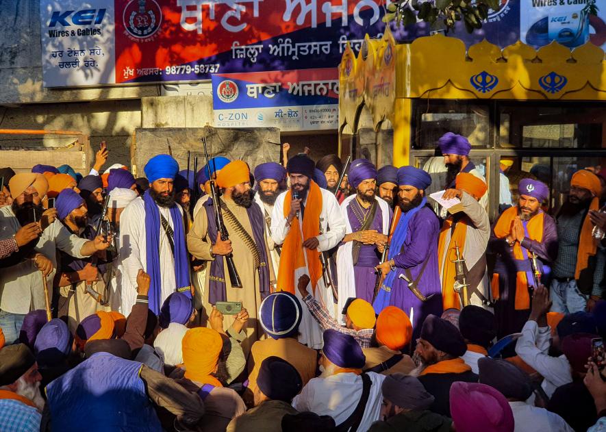 Waris Punjab De' founder Amritpal Singh along with his supporters arrive at the police station demanding release of his associate, at Ajnala near Amritsar, Thursday, Feb. 23, 2023