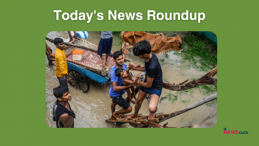 People from low-lying areas around the Yamuna river help one another relocate to a safer place after their houses were submerged in the swollen river, in New Delhi, Wednesday, July 12, 2023.