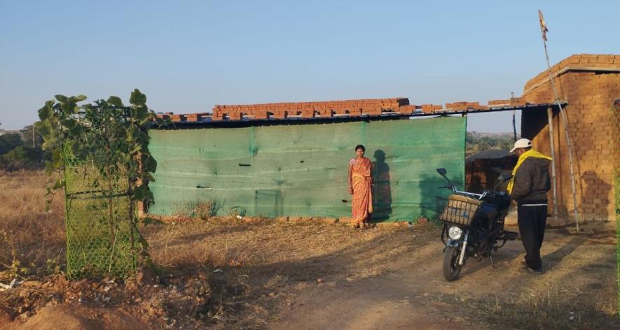 Sunil Singh's wife Veena Devi standing outside their shop built on the land that the university intended to acquire (Photo - Nisha Kumari, 101Reporters)